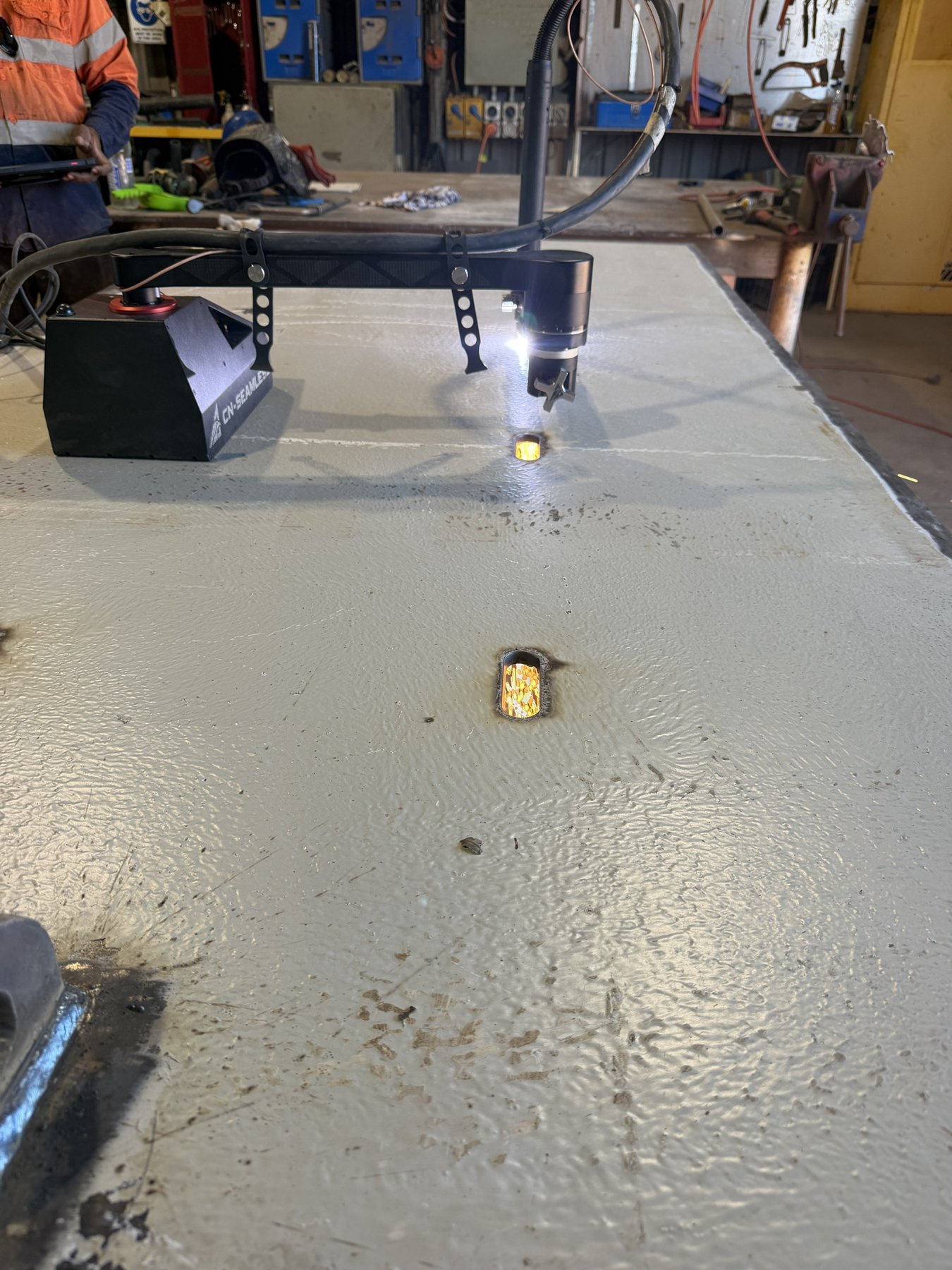 Portable CNC plasma cutter cutting slot weld openings in a 10 mm steel doubler plate in the Bing Bong workshop